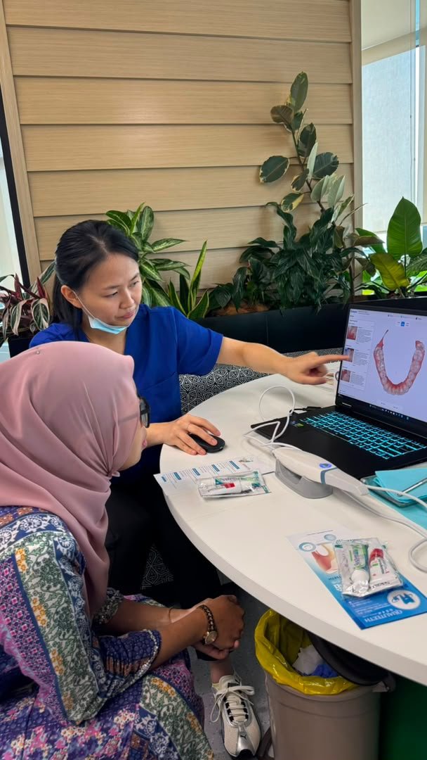 Dentist examining a staff member at a corporate screening