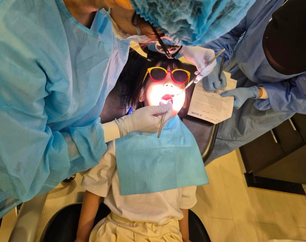 Qualiteeth dentist checking a pupil during the dental awareness programme at Knewton International School